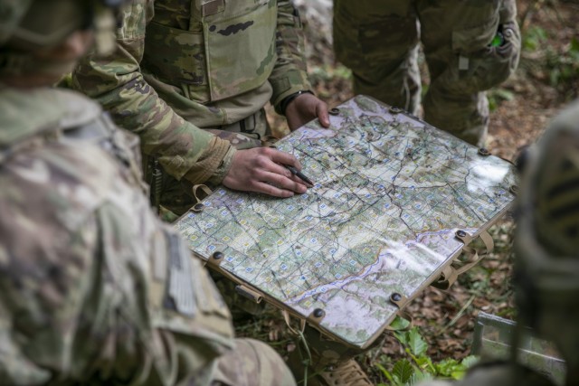 Soldiers with 5-7 Cavalry, 1st Armored Brigade Combat Team, 3rd Infantry Division reference a training area map with strategic annotations while planning troop movements during exercise Combined Resolve 25-2 at Hohenfels, Germany on May 17, 2025....