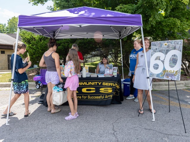 Army Community Service staff members celebrate the program’s 60th birthday at Fort Knox, Kentucky, July 7, 2025. The early celebration featured free children’s books and popsicles as well as information on ACS resources. The ACS program’s...