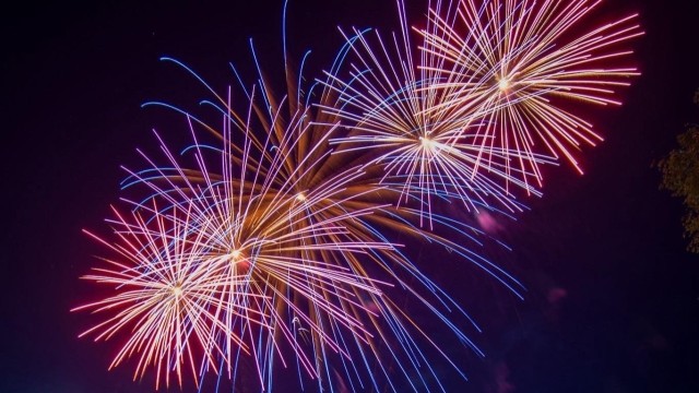 Fireworks explode over the Dugway parade field, lighting up the night sky.