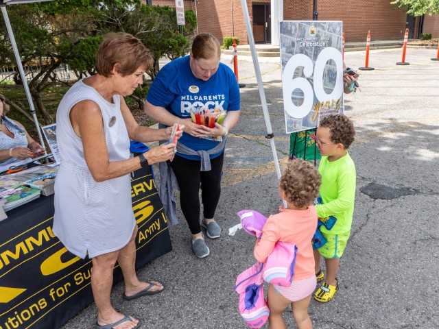 Army Community Service staff members celebrate the program’s 60th birthday at Fort Knox, Kentucky, July 7, 2025. The early celebration featured free children’s books and popsicles as well as information on ACS resources. The ACS program’s...