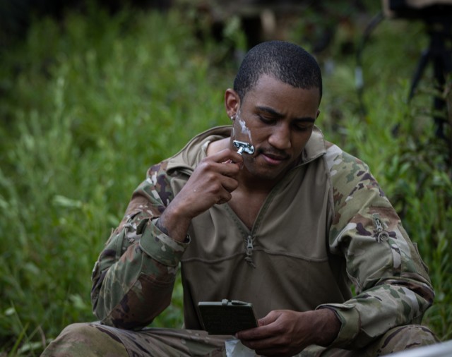 1st Lt. Jean Paul Stassi Jr., battalion IT support officer, shaves in the field before starting training, Camp Shelby, July 24, 2024. The overall focus of the unit's annual training was to instill the fundamentals and proficiency of battalion,...
