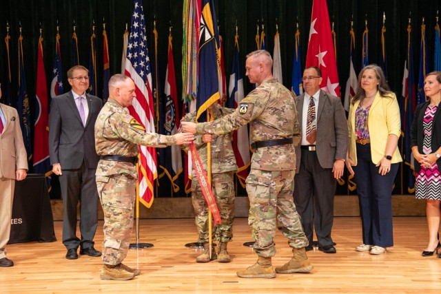 Lt. Gen. Miles Brown, Army Futures Command deputy commanding general, left, and Maj. Gen. John Cushing, U.S. Army Combat Capabilities Development Command, or DEVCOM, commanding general, prepare to attach the Army Superior Unit Award streamer to...