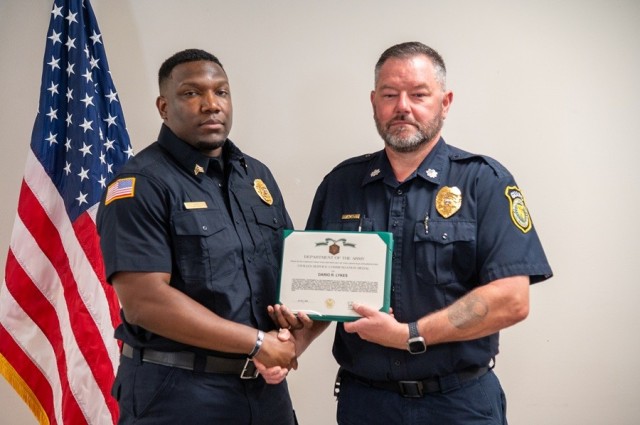 Sgt. Dario Lykes receives the Security Guard of the Year award from Jonathan Arcand, Redstone’s chief of security guards.