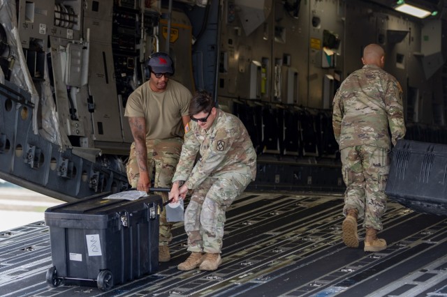 Soldiers from the 1st Battalion, 14th Field Artillery Regiment (1-14th FAR) load equipment and vehicles onto a C-17 aircraft as part of Strategic Airlift (STRATAIR) operations at the Lawton Regional Airport June 30, 2025. 1-14th FAR deployed to...