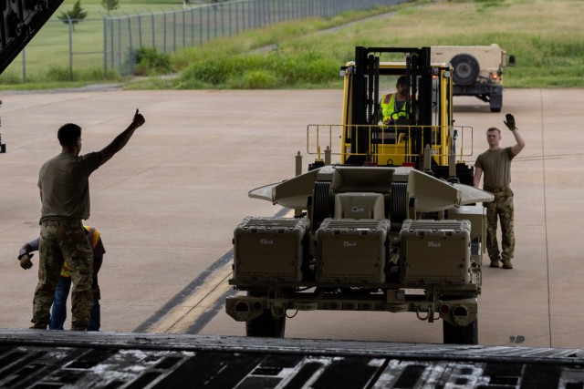 Soldiers from the 1st Battalion, 14th Field Artillery Regiment (1-14th FAR) load equipment and vehicles onto a C-17 aircraft as part of Strategic Airlift (STRATAIR) operations at the Lawton Regional Airport June 30, 2025. 1-14th FAR deployed to...