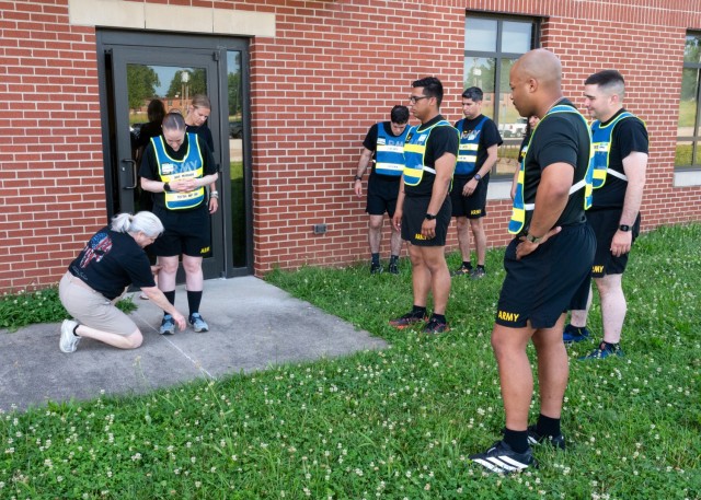 Vonnie Hitchcock (kneeling), 795th Military Police Battalion athletic trainer, teaches 14th Military Police Brigade drill sergeants and cadre the pose method of running June 24, during a unit training event held in the Main Post Chapel. After...