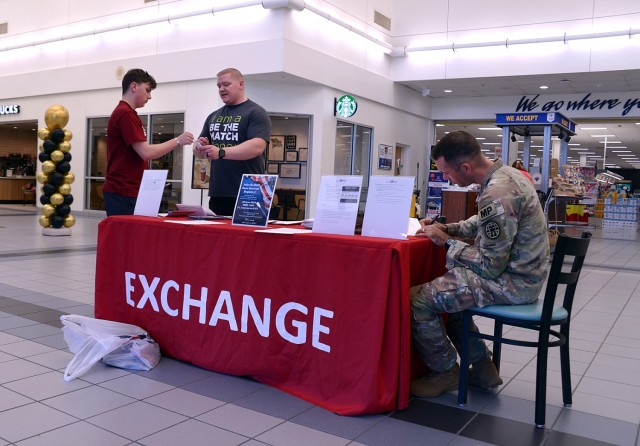 Shopper Jacob Yost takes a mouth swab from bone marrow registry drive coordinator Staff Sgt. Chris Womack, Combined Arms Center Law Enforcement Activity, as Staff Sgt. Chad Addison, Midwest Joint Regional Correctional Facility Battalion...