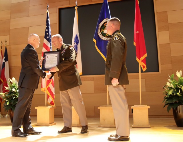 Brig. Gen. Ed Barker (center), the Program Executive Officer for Intelligence, Electronic Warfare & Sensors, passes the charter from Kenneth Strayer (left), outgoing Project Manager for Electronic Warfare & Cyber, to Col. Scott Shaffer (right),...