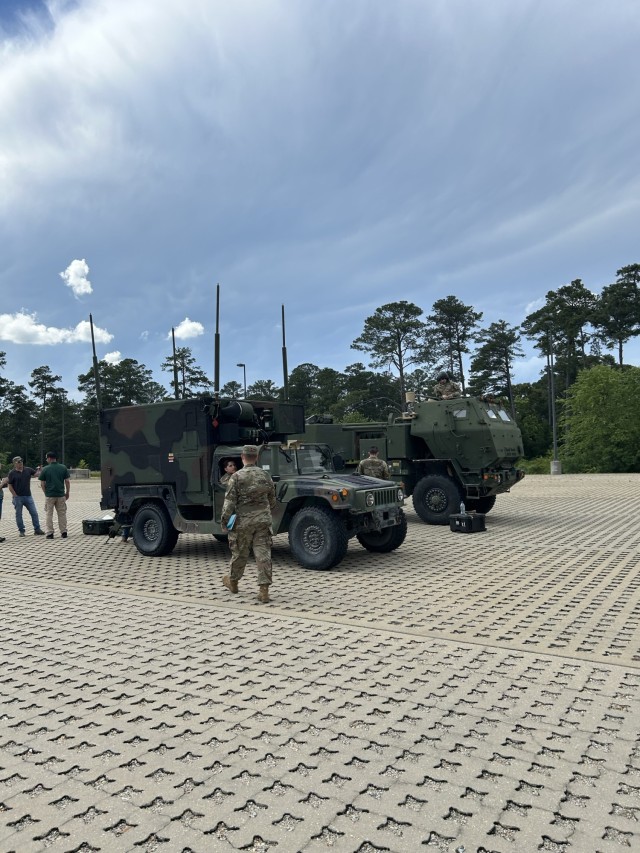 Soldiers and engineers stand by an M142 High-Mobility Artillery Rocket System (HIMARS) and the Fire Direction Center at the Fort Bragg Mission Training Center as they participate in a transformation event demonstrating the Army’s modernized...
