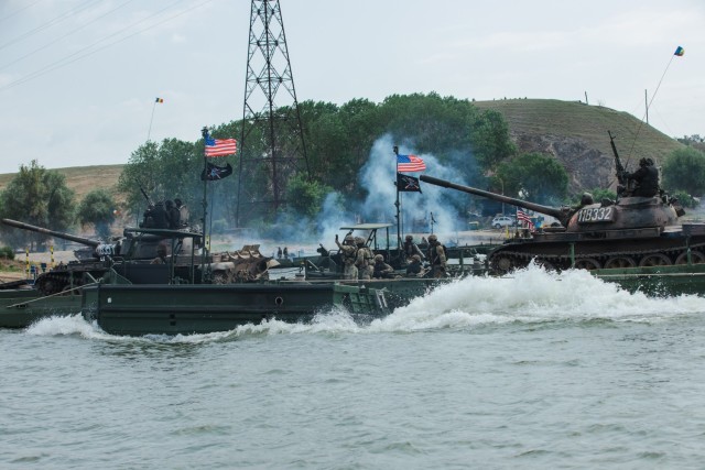 U.S. Soldiers assigned to 7th Engineer Brigade, 21st Theater Sustainment Command, transports Italian VBM Freccia at a wet gap crossing during exercise Saber Guardian 25 in Frecatei, Romania.