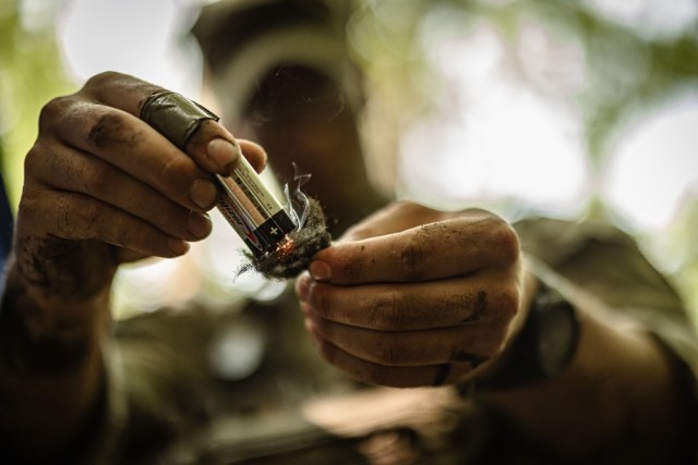Cadets learn how to start a fire while receiving survival instruction from task force soldiers from the 101st Airborne Division June 10 during Cadet Summer Training. Photo by Jorge Garcia/ USMA-PAO.