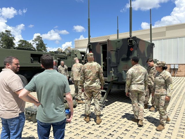 During a transformation event at the Fort Bragg Mission Training Center in May 2025, Soldiers and engineers prepare to send an “end-to-end” fires thread mission for the first time from the Artillery Execution Suite (AXS) to an M142...