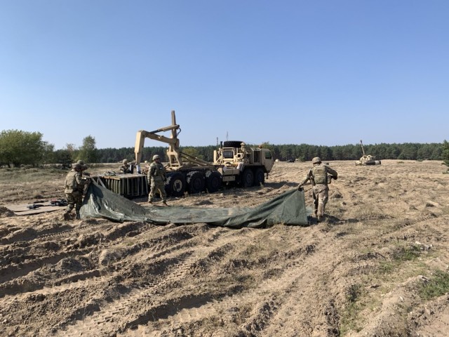 Soldiers from F FSC Distro Platoon unload pallets of M795 to facilitate resupply operations during Artillery Table XV at Forward Operation Site, Torun, Poland, September 2024.