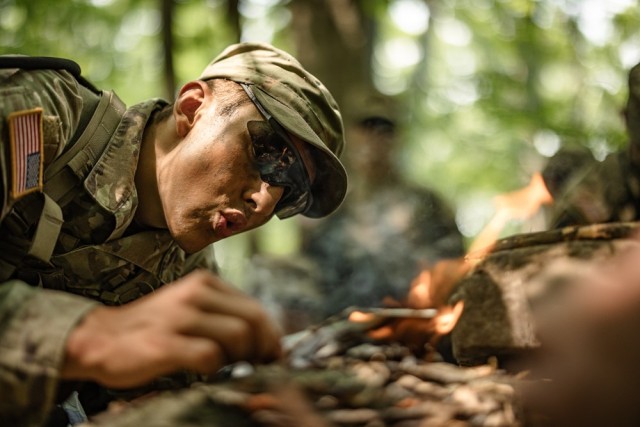 Cadets learn how to start a fire while receiving survival instruction from task force soldiers from the 101st Airborne Division June 10 during Cadet Summer Training. Photo by Jorge Garcia/ USMA-PAO.
