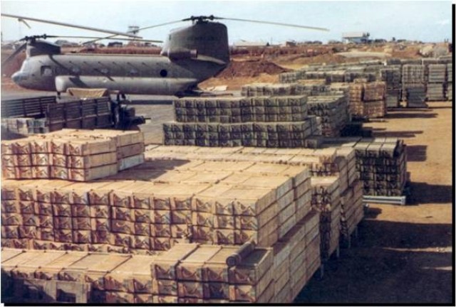 A forward ammunition supply point and a CH-47 helicopter being loaded with ammunition at Pleiku, South Vietnam.