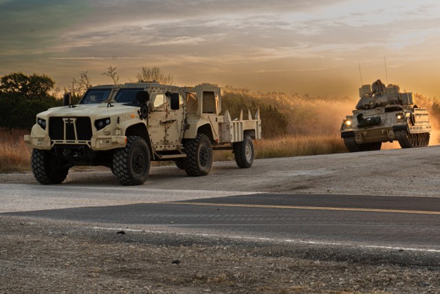 Army Joint Light Tactical Vehicle and a Bradley Fighting Vehicle, assigned to the 1st Cavalry Division, III Armored Corps, conduct convoy operations on Fort Hood, Nov. 13, 2024.