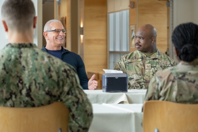 Chef Robert Irvine holds a roundtable discussion with Soldier, Sailors, and Airmen assigned to Alexander T. Augusta Military Medical Center during a tour of Fort Belvoir Thursday, July. 10. The group discussed potential changes to military dining...