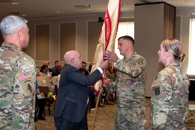 After passing the colors, outgoing Fort Leavenworth Garrison Commander Col. Duane Mosier watches as Installation Management Command-Training Director William Kidd passes the colors to incoming Fort Leavenworth Garrison Commander Col. Todd Sunday,...