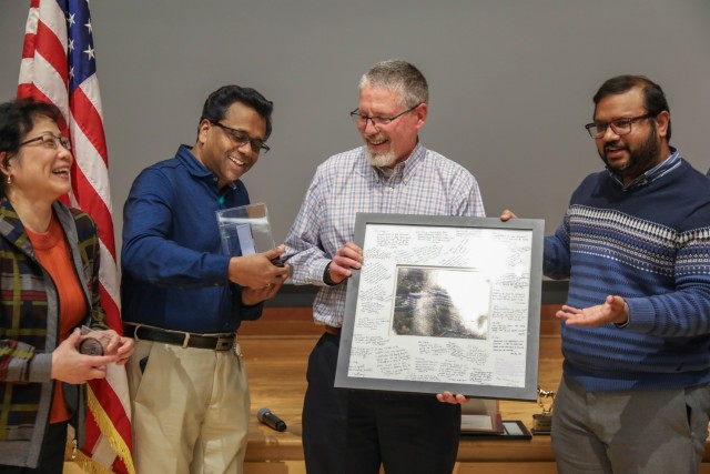 Dr. Joseph Long, Retired Supervisory Research Physiologist, Walter Reed Army Institute of Research, stands with his colleagues from WRAIR’s Blast Induced Neurotrauma Branch as they present him with gifts during his surprise retirement...