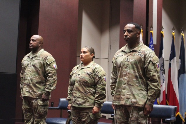 Standing for the singing of the national anthem at Friday’s ceremony are HHC AMCOM’s outgoing 1st Sgt. Michael Mills, commander Capt. Maria Salih and Master Sgt. Timothy Edgerton, the new first sergeant.