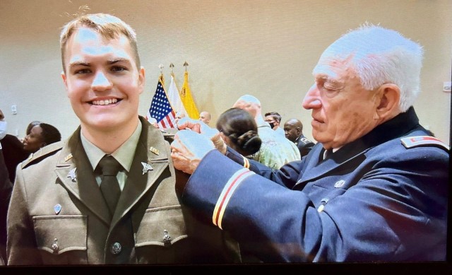 Lt. Col. (Ret.) Stephen Harmon adjusts 2nd Lt. Christopher Harmon’s rank after his commissioning ceremony.