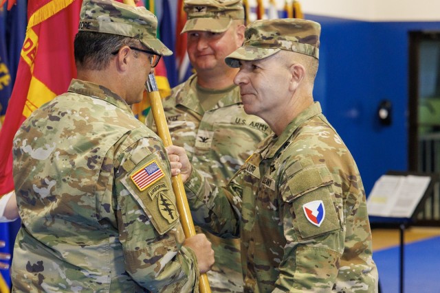 Maj. Gen. Michael Lalor, U.S. Army Tank-automotive and Armaments Command Commanding General passes Anniston Army Depot&#39;s unit colors to incoming ANAD Commander Col. Charles Moore, signaling the symbolic transfer of command of ANAD to Col. Moore.