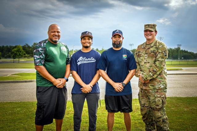 Coaches with the Fort Gordon Braves youth baseball team pose for a group photo at Fort Gordon, July 22. From left: Gerard Arnett, TJ Lindo, head coach Tony Lindo, and Staff Sgt. Austin Bryan. The Braves recently secured their fourth consecutive...