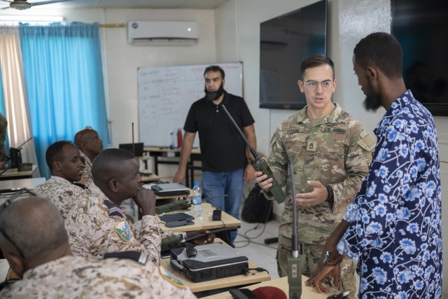 U.S. Army Sgt. 1st Class Garrett Hufana, center, information technology specialist with the 149th Maneuver Enhancement Brigade, Kentucky Army National Guard, participates in a radio communications knowledge exchange with Djiboutian soldiers at the...