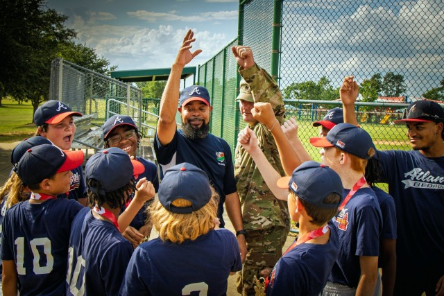 Coaches and players with the Fort Gordon Braves youth baseball team rally together for a post-season photo at Fort Gordon, Georgia, July 22. The image was taken a week after the team clinched their fourth consecutive YMCA league title and does not...