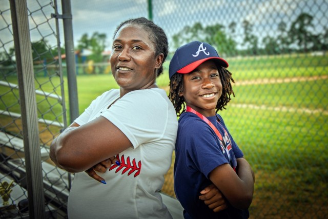 Langston Walker, star pitcher for the Fort Gordon Braves, stands with his mother, Asanti Walker, during a post-season photo session at Fort Gordon, Georgia, July 22. Langston pitched a no-hitter in the team’s final game as the Braves clinched...