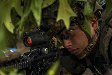 A Paratrooper assigned to Alpha Company, 1st Battalion, 505th Parachute Infantry Regiment, 3rd Brigade Combat Team, 82nd Airborne Division, pulls security at night while acting as the opposing force during Devil Avalanche, at Fort Bragg, North Carolina, July 22, 2025. During Devil Avalanche, Paratroopers train to operate in periods of darkness, build proficiency on key weapon systems, and sustain the force throughout the exercise.