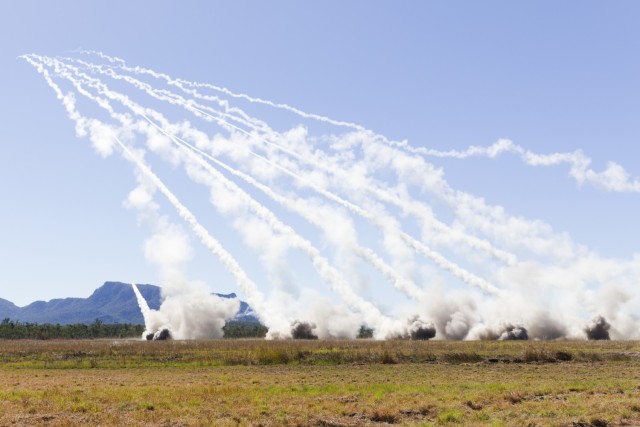 Rockets streak into the air from six M142 High Mobility Artillery Rocket Systems during a combined live-fire portion of Exercise Talisman Sabre 25 in Queensland, Australia, July 14, 2025.