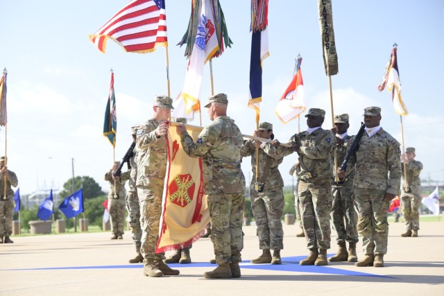 From left, Col. Mark McClellan, U.S. Army Garrison-Fort Hood commander, and Command Sgt. Maj. Loyd Rhoades, U.S. Army Garrison-Fort Hood command sergeant major, uncase the colors for Fort Hood during the Fort Hood redesignation ceremony July 28,...