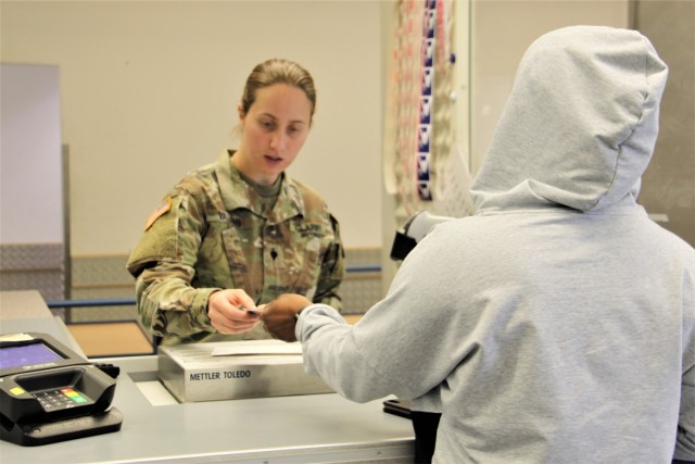 A postal clerk serves a customer at the Baumholder Postal Service Center.