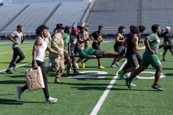 Fort Hood Soldiers tackle team building with DeSoto High School football