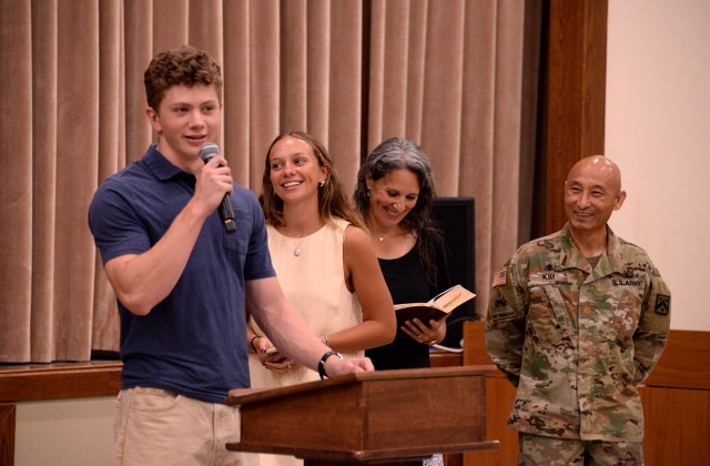 Seventeen-year-old John Bryan offers his prayer intentions for the Chaplain Corps during the corps' 250th anniversary celebration luncheon July 29, 2025, at Frontier Chapel at Fort Leavenworth, Kansas. His sister, Berea, and mom, Jody, family...