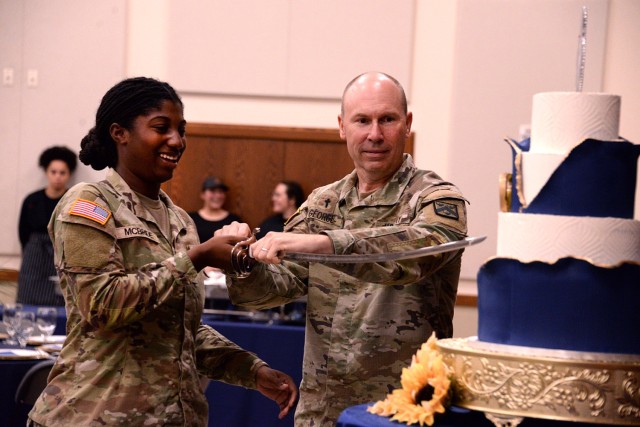 Pfc. Gabriel McBride, religious affairs specialist at her first duty station, and Chaplain (Col.) Seth George, Combined Arms Center senior command chaplain, cut a cake to celebrate the Chaplain Corps' 250th anniversary during a luncheon July...
