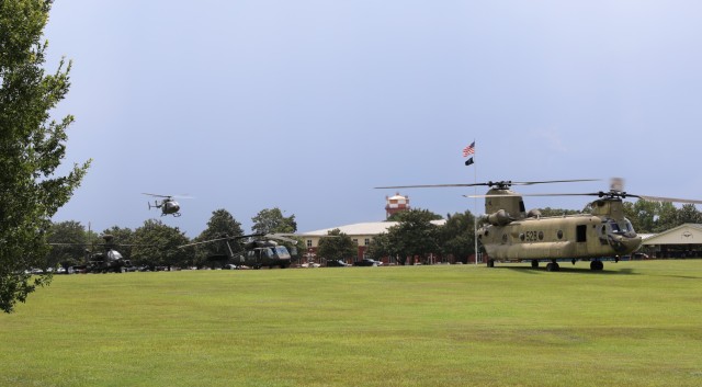 Army aircraft that were provided as static displays take off from the parade field at the close of the Aviation Center of Excellence's Aviation Industry Days event at Fort Rucker, Ala., July 30, 2025. (U.S. Army photo by Kelly Morris)