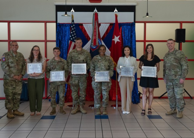 Volunteer of the Quarter recipients pose alongside Command Sgt. Maj. Randolph Delapena and Maj. Gen. Pat Work, the 82nd Airborne Division’s command team, during the ceremony at the Division’s Culinary Arts Training Center, Fort Bragg, North...