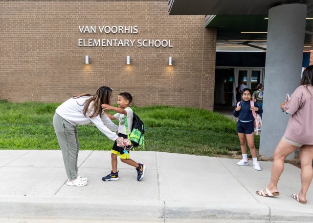 The Van Voorhis Elementary School faculty and school mascot welcomes students to the 2025-26 school year at Fort Knox, Kentucky, Aug. 4, 2025. Fort Knox senior enlisted leader Command Sgt. Maj. Alex Licea also joined in welcoming students and...