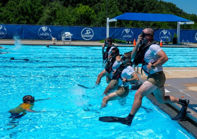 Graduates from the Army Diver Prequalification Course conduct the water entry procedure which prepares them for entering the water while in full gear. Using proper position ensures gear stays in place as the diver enters the water.