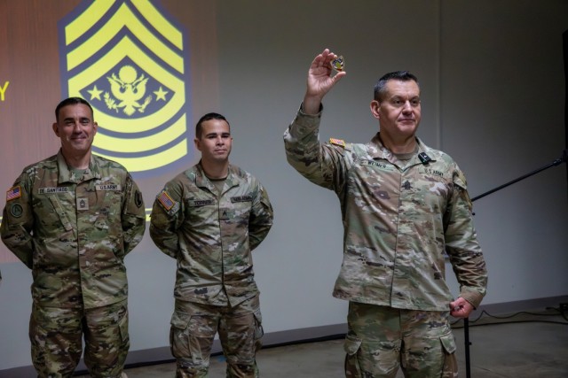 Sgt. Maj. of the Army Michael R. Weimer holds a Sergeant Major of the Army Coin of Excellence during a town hall at the Puerto Rico National Guard’s headquarters at Fort Buchanan, Puerto Rico, Aug. 4, 2025.