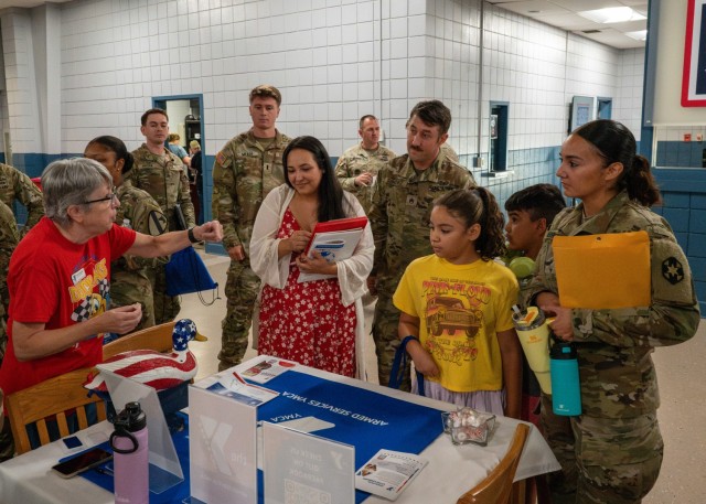 Community Fair attendees stop a booth July 24 at the USO to learn more about resources available to Fort Leonard Wood service members and families.
