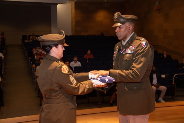 (From left) Sgt. Maj. Jennifer Bell, the U.S. Army Communications-Electronics Command G3/5 operations sergeant major, presents the U.S. flag to Col. Reginald M. Harris, the U.S. Army Communications-Electronics Command director of Plans and...