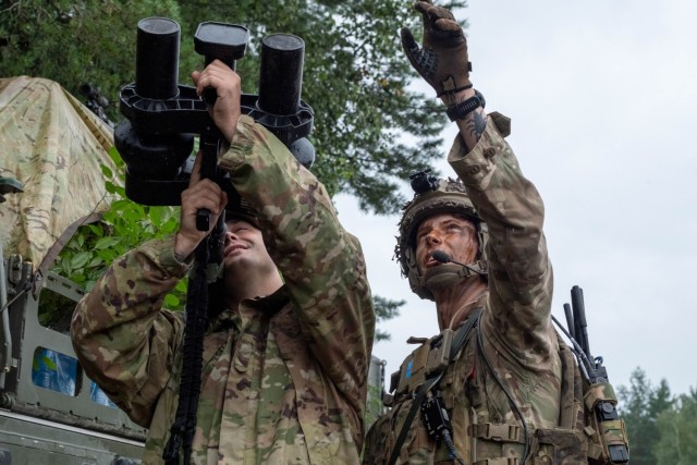 A U.S. Army Soldier receives instructions from a British Army Soldier on a Night Fighter portable electronic jamming device during a series of counter-UAS training events.
