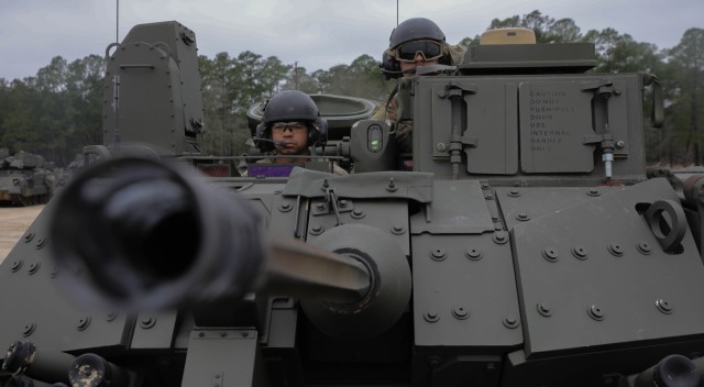 U.S. Army Sgt. Cris Flores, left, and Spc. Jordan Byington, both infantrymen assigned to 1st Battalion, 64th Armor Regiment, 3rd Infantry Division, operate a Bradley Fighting Vehicle at Fort Stewart, Georgia, Feb. 8, 2024. Hatches are positioned...