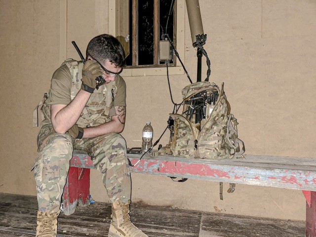 Spc. Robert Bowley, an electromagnetic warfare specialist with the 37th Infantry Brigade Combat Team, radios from his position while monitoring the electromagnetic spectrum with the Beast+ system during Northern Strike at Camp Grayling, Michigan,...