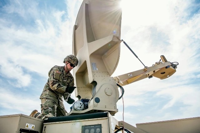 A CECOM Soldier maintains a satellite.