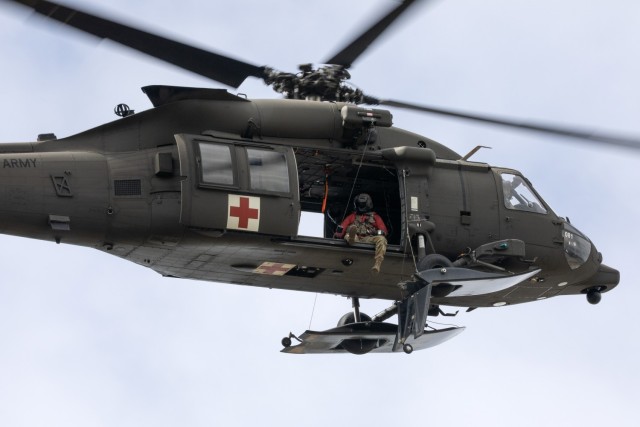 Alaska Army National Guard HH-60M MEDEVAC Black Hawk aviators assigned to Golf Company, 2-211th General Support Aviation Battalion, conduct a hoist training demonstration while hosting mission partners for a multi-agency hoist symposium at Bryant...
