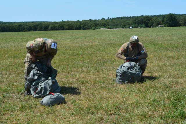 DEVCOM Soldier Center Staff Sgts. Jovani Tankelewicz, left, and Kavon Nieto, right, recover their MC-6 parachutes after their third and final jump during Leapfest 2025, the International Military Parachute Competition.
